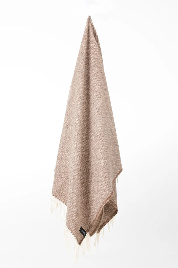 Palliser Ridge Herringbone throw in Chocolate hanging in full drape, showing the fringed edge