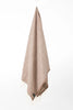 Palliser Ridge Herringbone throw in Chocolate hanging in full drape, showing the fringed edge