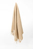 Palliser Ridge Herringbone throw in Mustard hanging in full drape, showing the fringed edge