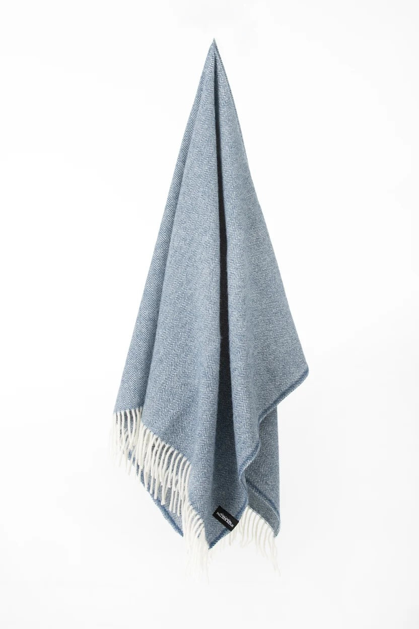 Palliser Ridge Herringbone throw in Royal Blue hanging in full drape, showing the fringed edge