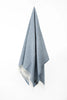 Palliser Ridge Herringbone throw in Royal Blue hanging in full drape, showing the fringed edge
