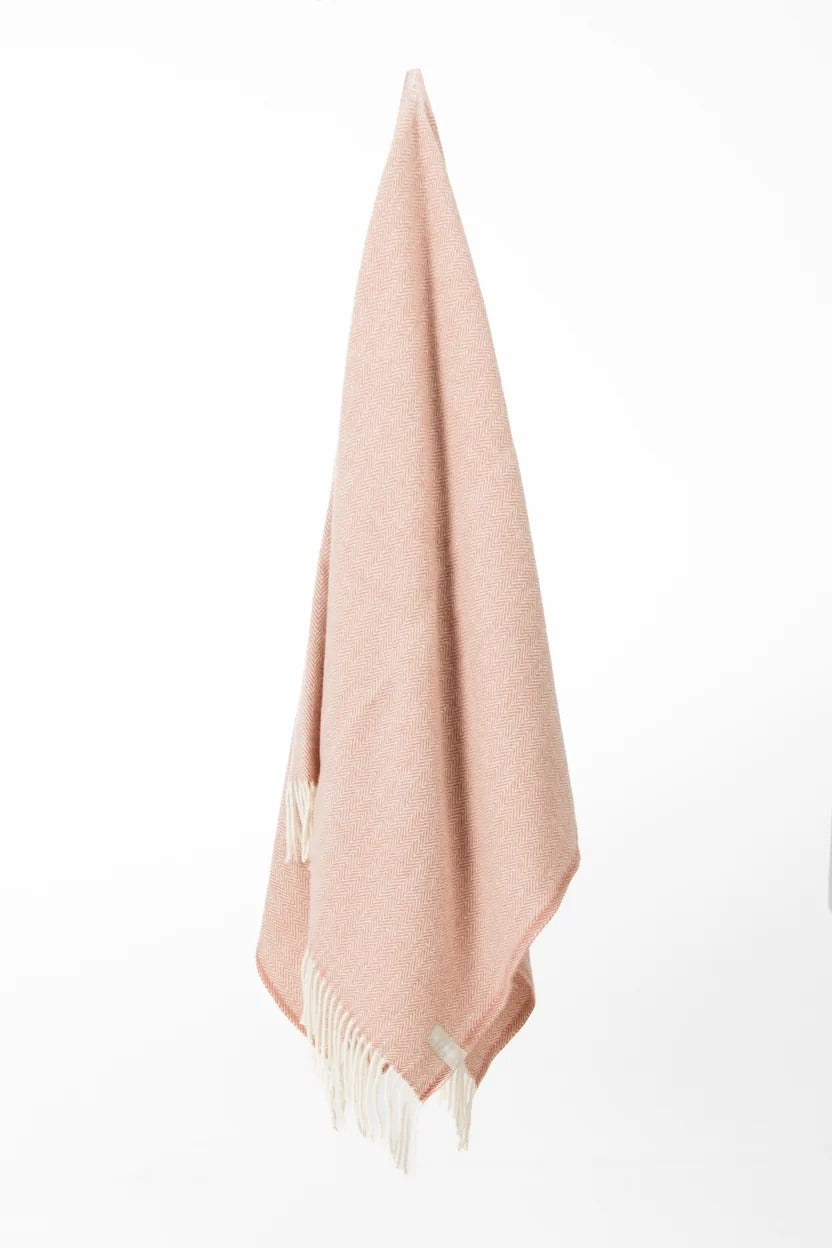 Palliser Ridge Herringbone throw in Blush hanging in full drape, showing the fringed edge