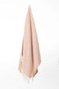 Palliser Ridge Herringbone throw in Blush hanging in full drape, showing the fringed edge