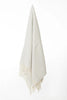 Palliser Ridge Herringbone throw in Dove Grey hanging in full drape, showing the fringed edge