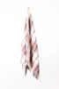 Palliser Ridge Twill Check lambswool throw in Blush, hanging to show the full check pattern