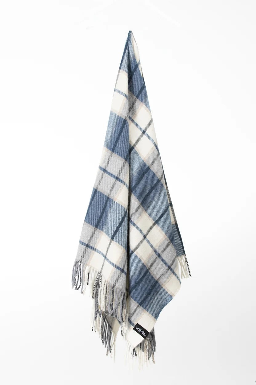 Palliser Ridge Twill Check throw in Royal Blue hanging in full drape, showing the check pattern and fringed edge