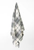 Palliser Ridge Twill Check lambswool throw in Forest, hanging to show the full check pattern