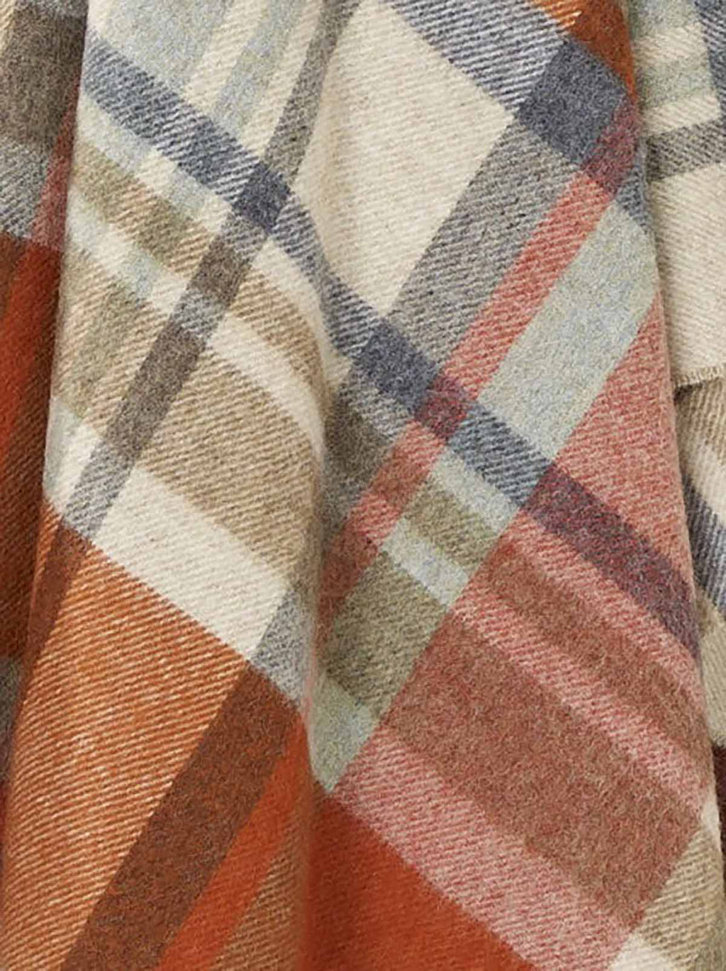 Close up of the gorgeous weave and rich warm colours of a 100% premium merino throw blanket. 