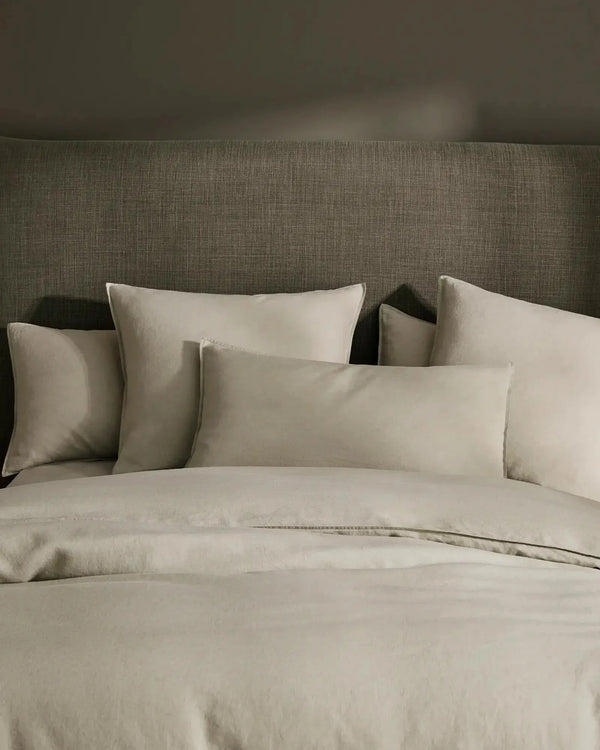 Close up of the Weave Home Ravello premium French flax linen bedding displayed in a contemporary bedroom 