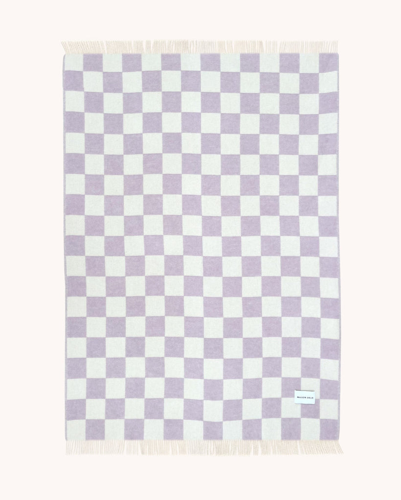 A full view of the reversible wool throw blanket in Checkerboard Lilac White by Maison Deux