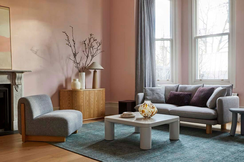 A beautiful soft viscose blend statement rug in shades of muted ocean blue, by Globe West and Soren Liv NZ, situated in a stylish living room. 