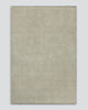 A full image of a soft grey-beige neutral floor rug in 100% wool with fringed edges by Baya. 