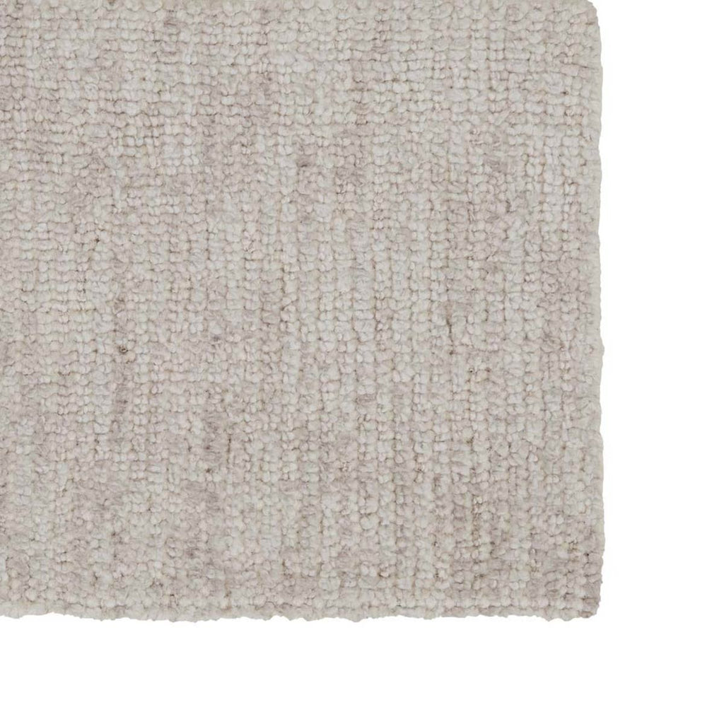 Close up of the corner of a creamy silver floor rug made with a wool blend, by Soren Liv NZ and Globe West.