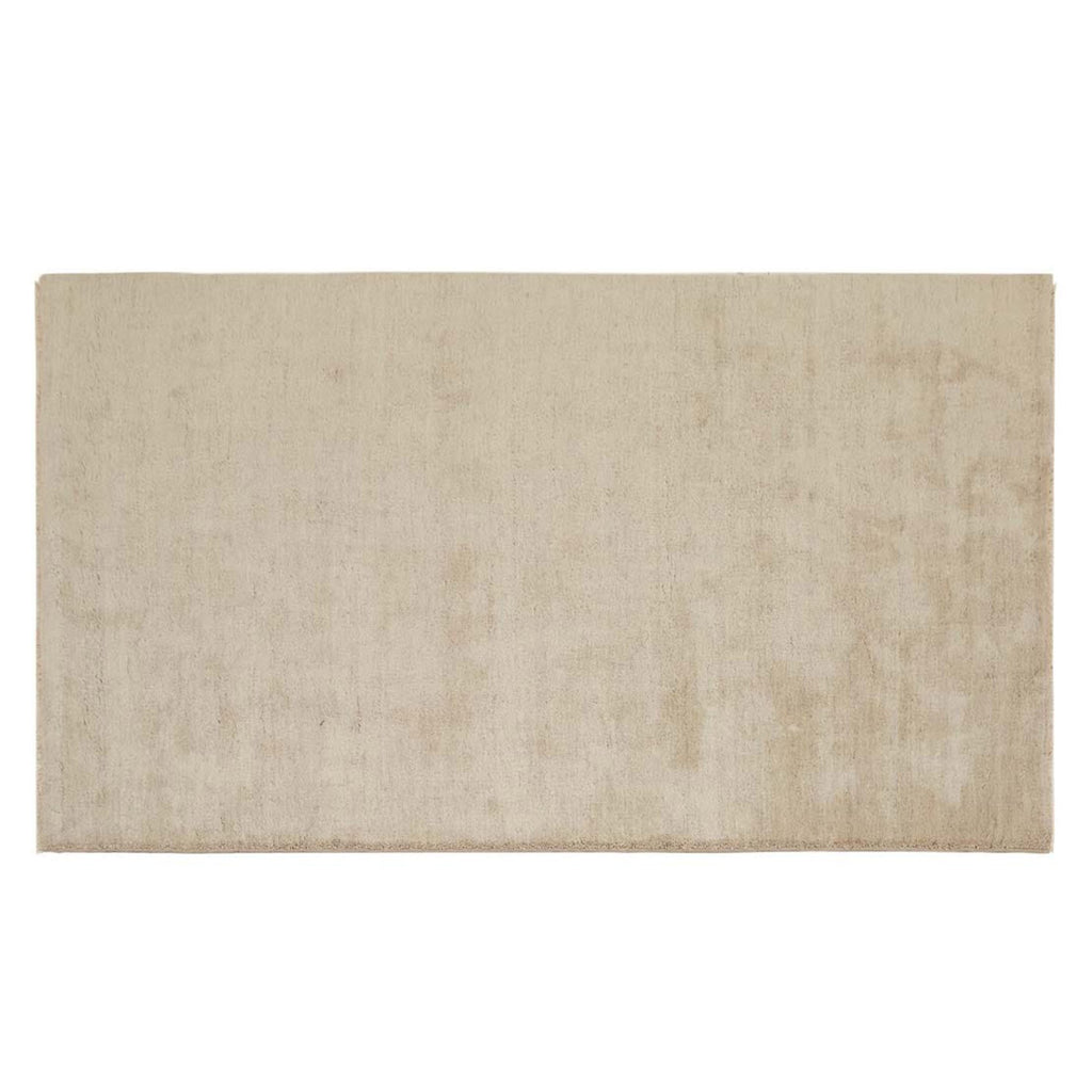 Full view of a soft handloomed rug in a soft beige Pumice colour by Soren Liv. The edges are lightly fringed