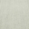 Close up of the weave of a handmade, 100% wool floor rug by Soren Liv NZ and Globe West, in subtle shades of light blue and green, shades of seafoam. 