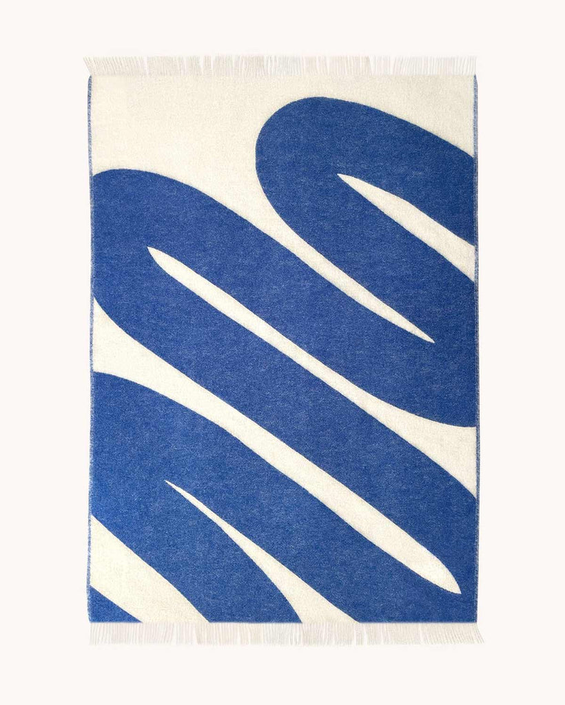 Full view of the Swirl patterned throw in shade Cobalt White by Maison Deux