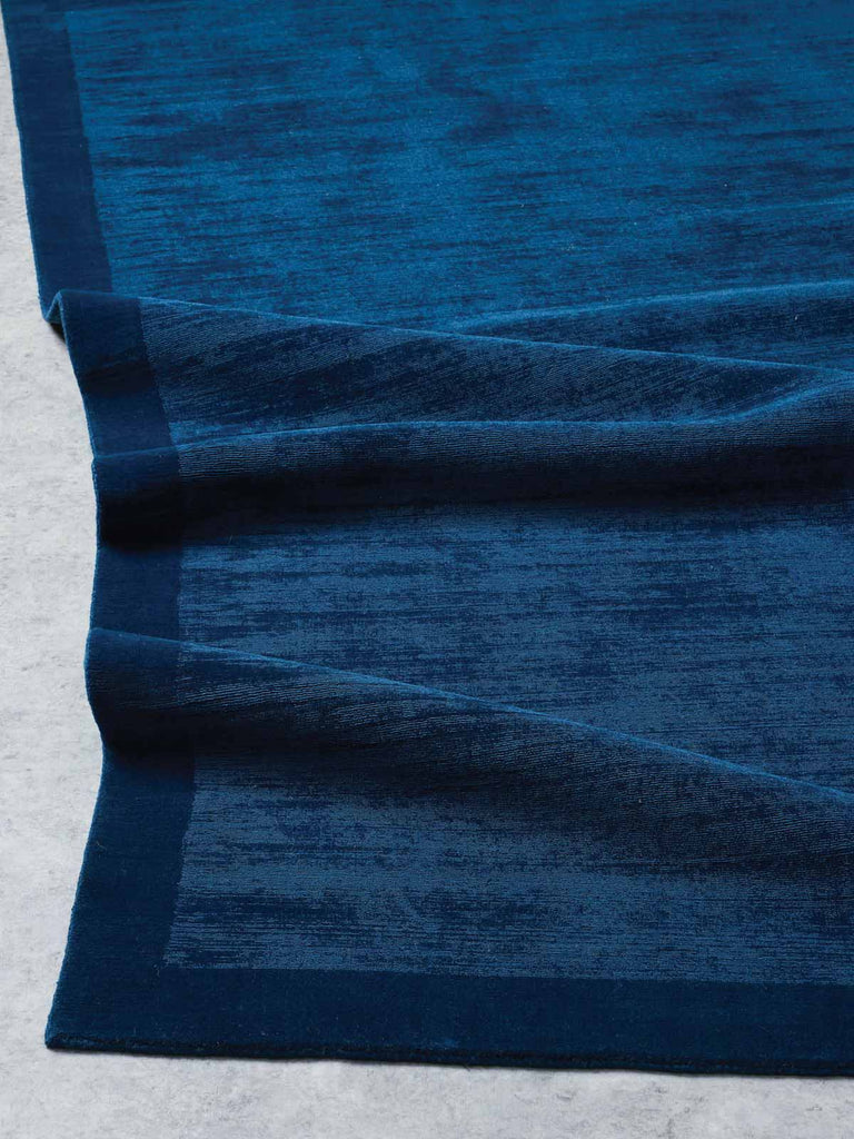 A deep, almost royal navy blue 100% New Zealand wool floor rug from Tribe Home. 
