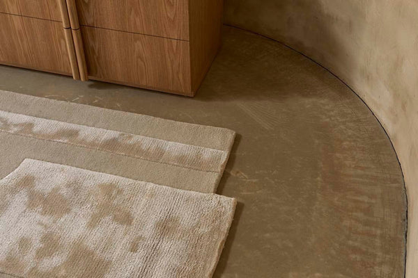 The edge of a cream, light natural beige floor rug with geometric designs rendered in alternating pile heights, by Globe West and Soren Liv NZ 