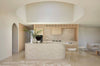 A cream, light natural beige floor rug with geometric designs rendered in alternating pile heights, by Globe West and Soren Liv NZ, situated in a modern kitchen.