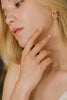 A woman wearing the Ubud chain link ring, a very delicate everyday ring, in 14k gold-fill. 