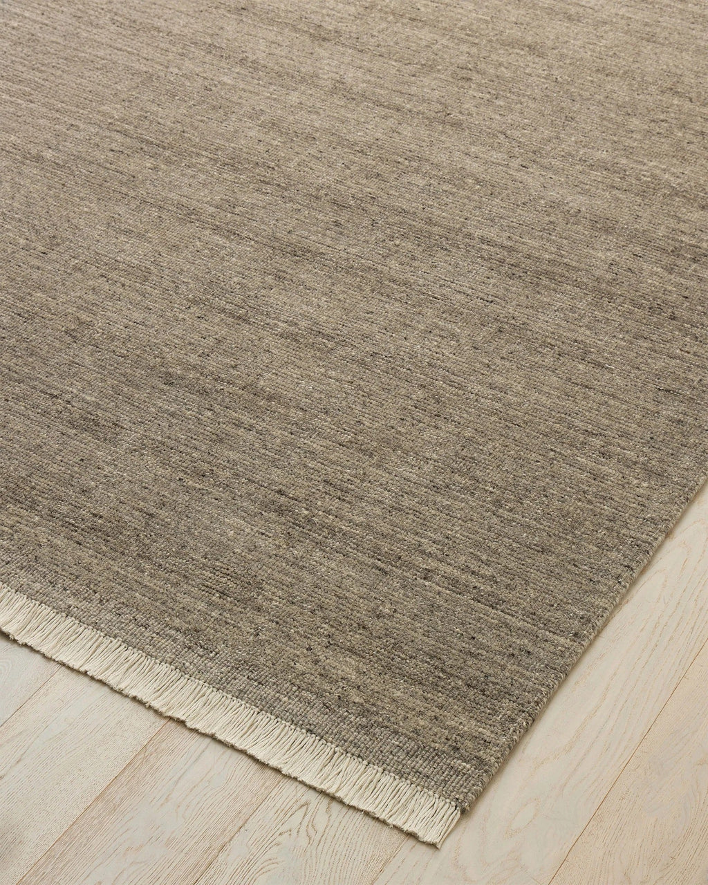Weave Home Anton wool rug in Ash on a pale timber floor