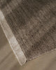 Weave Home Anton wool rug in Ash, close view of the cut and loop pile and cream cotton fringe