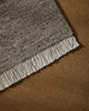 Weave Home Anton wool rug in Ash layered over a tan rug