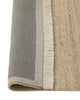 Weave Home Anton wool rug in Sand folded back to show the cotton backing and cream fringe