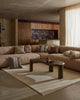 Weave Home Anton wool rug in Sand under a coffee table in a living room with a curved sofa