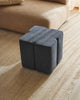 Weave Home Anton wool rug in Sand with a dark blue ottoman beside a tan sofa