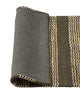 Corner of the Weave Home Arden jute doormat in Coal folded back to show the grey non-slip backing.