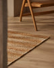 Weave Home Arden Jute Doormat in Natural placed near a timber chair