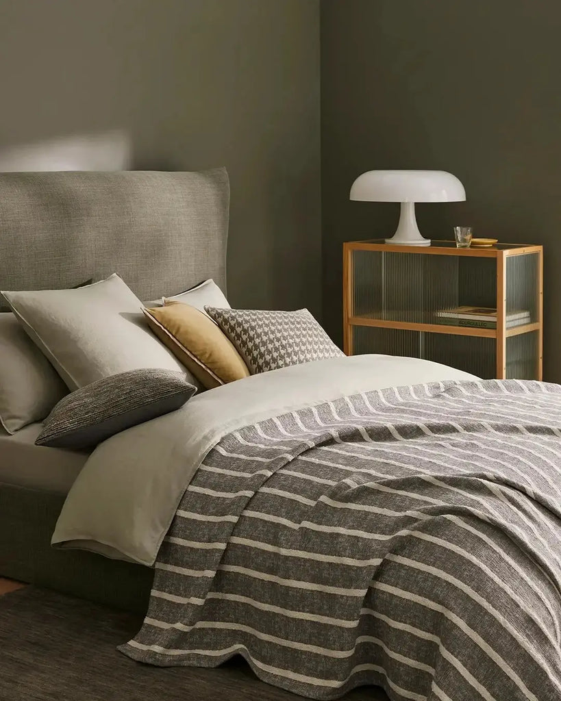 A stylish bedroom featuring Weave Home nz bedding and cushions