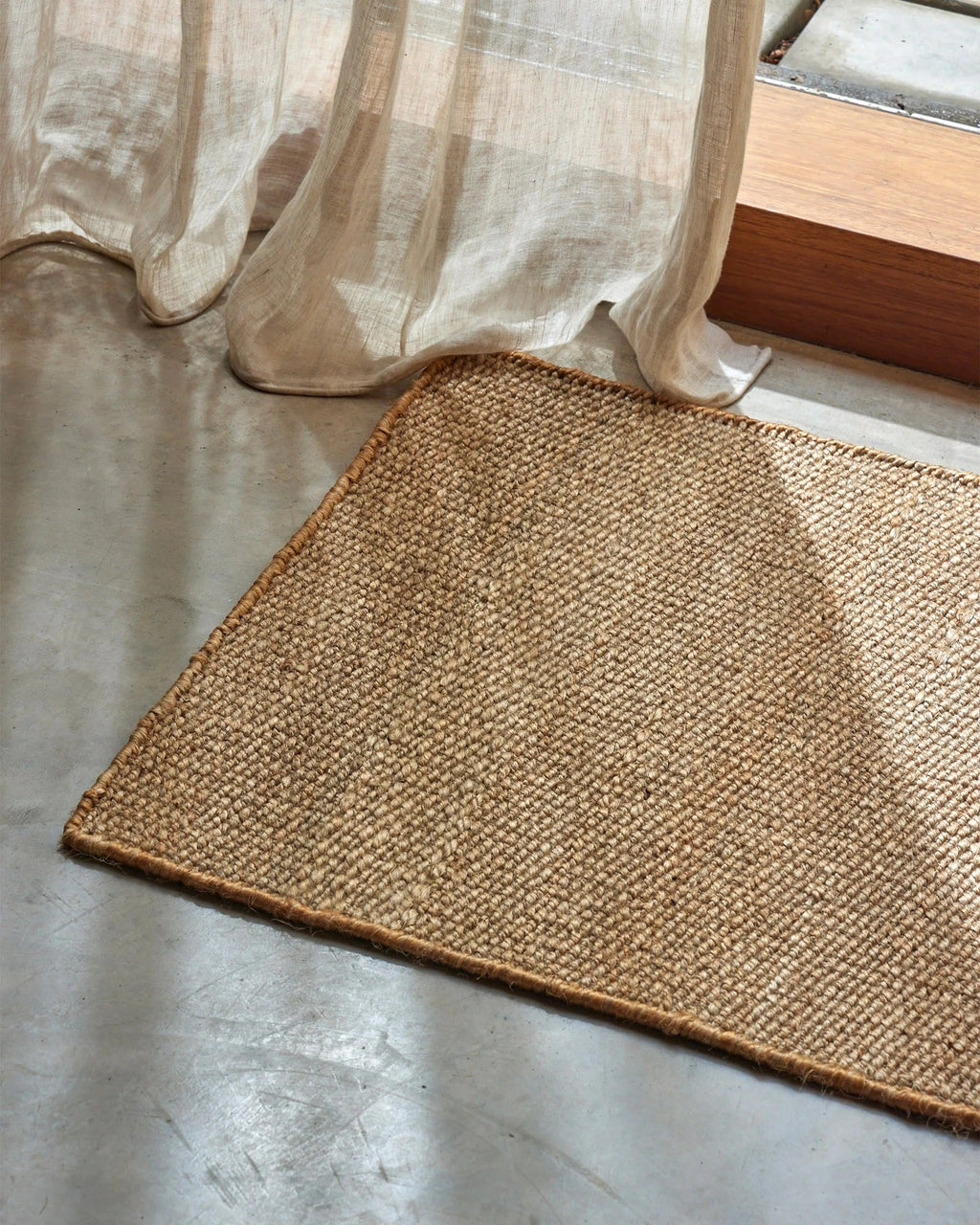 Weave Home Ivano jute doormat in Wheat at the base of a timber staircase.