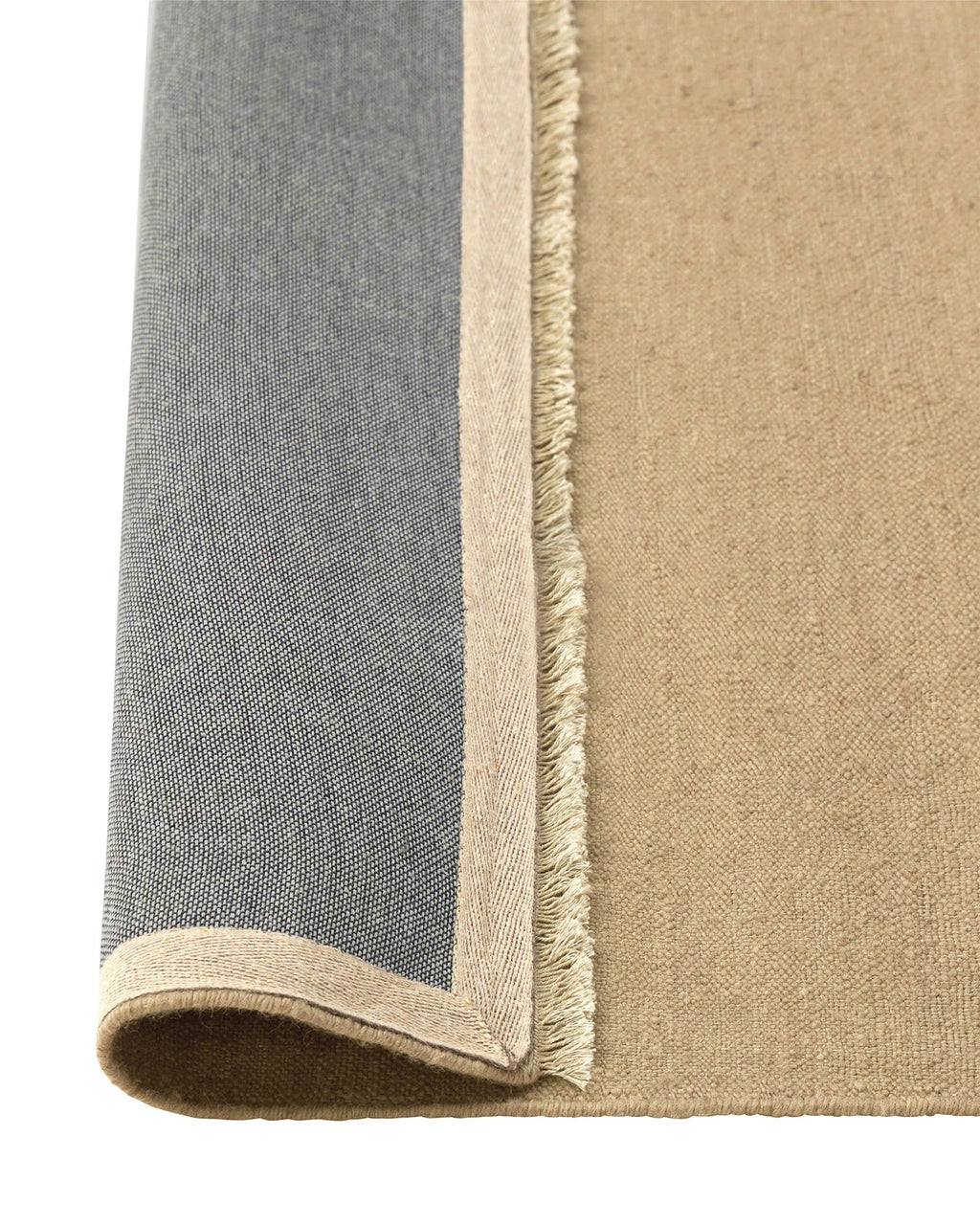 Weave Home Jacqueline wool rug in Barley, folded corner showing the cotton backing and fringed edge.