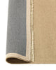 Weave Home Jacqueline wool rug in Barley, folded corner showing the cotton backing and fringed edge.