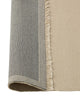 Weave Home Jacqueline wool rug in Cashew folded back to show the backing and fringe