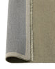 Weave Home Jacqueline wool rug in Pumice folded back to show the backing and fringe