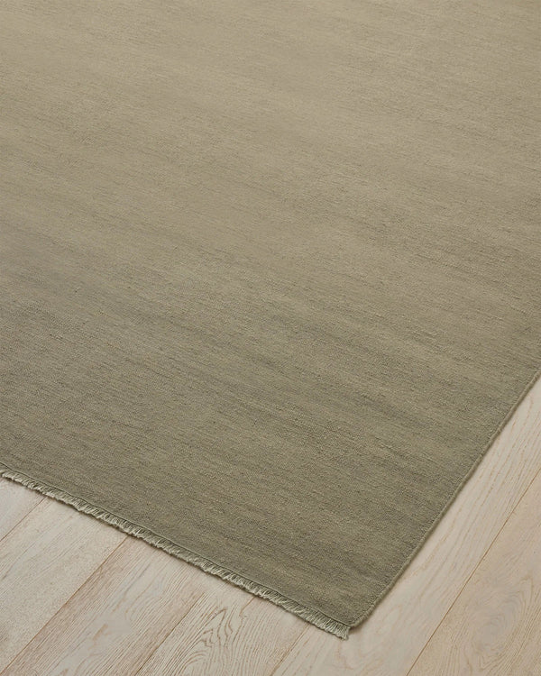 Weave Home Jacqueline wool rug in Pumice on a pale timber floor, showing the fringed corner