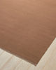 Weave Home Jacqueline wool rug in Rosewood on a pale timber floor, showing the fringed corner