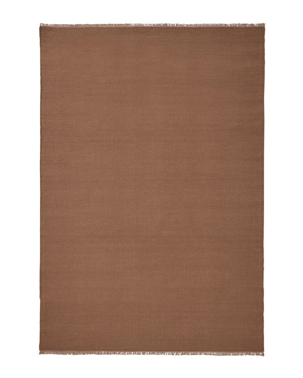 Weave Home Jacqueline wool rug in Rosewood on a plain background, shown flat with fringed ends