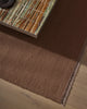 Weave Home Jacqueline wool rug in Rosewood, close view of the flatweave beneath a stone-topped table