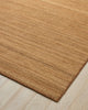 Weave Home Monroe jute rug in Biscuit on a pale timber floor, showing the stitched border and corner
