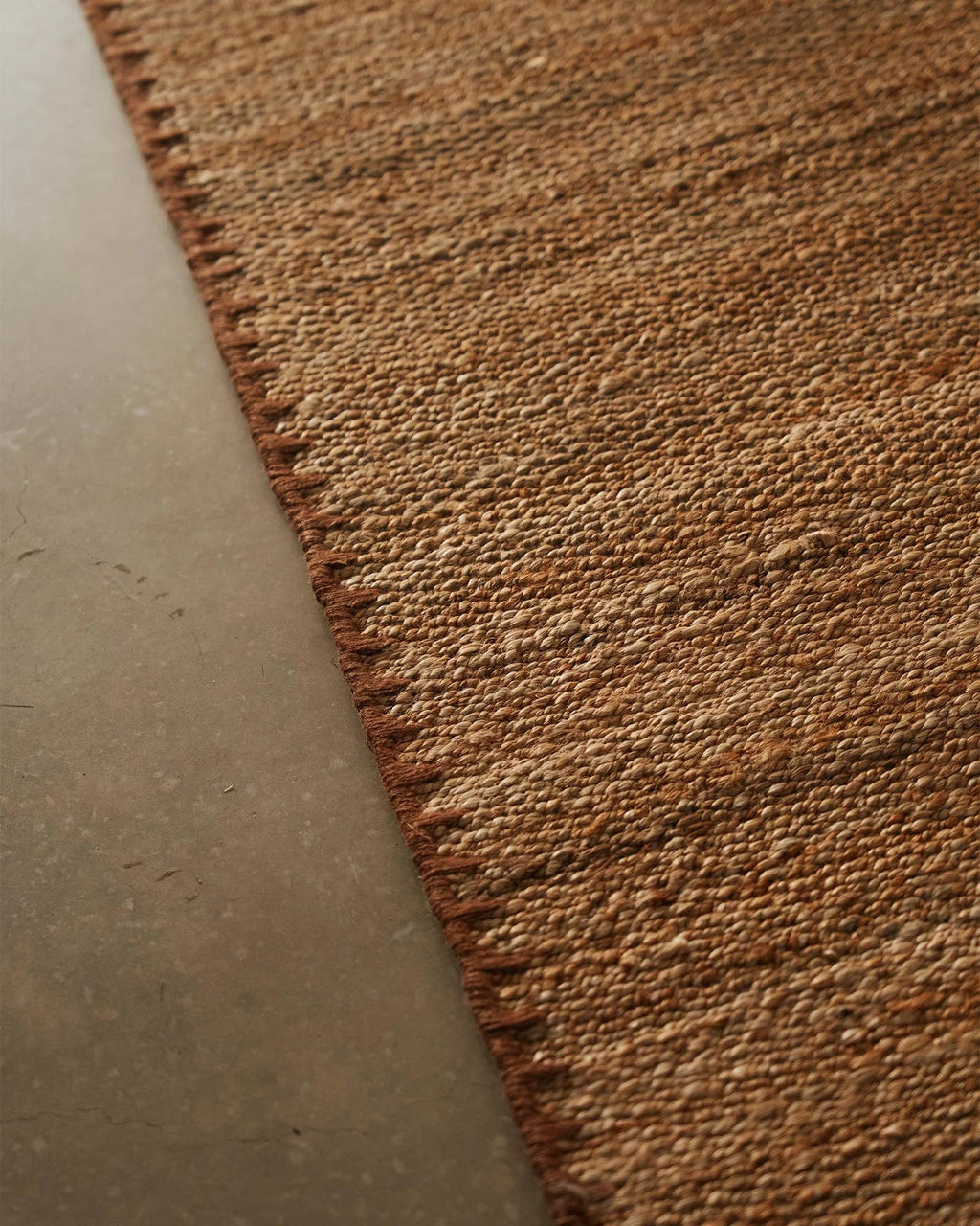 Weave Home Monroe jute rug in Biscuit, close view of the handwoven jute and blanket stitch border