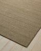 Weave Home Monroe jute rug in Flint on a pale timber floor, showing the stitched border and corner