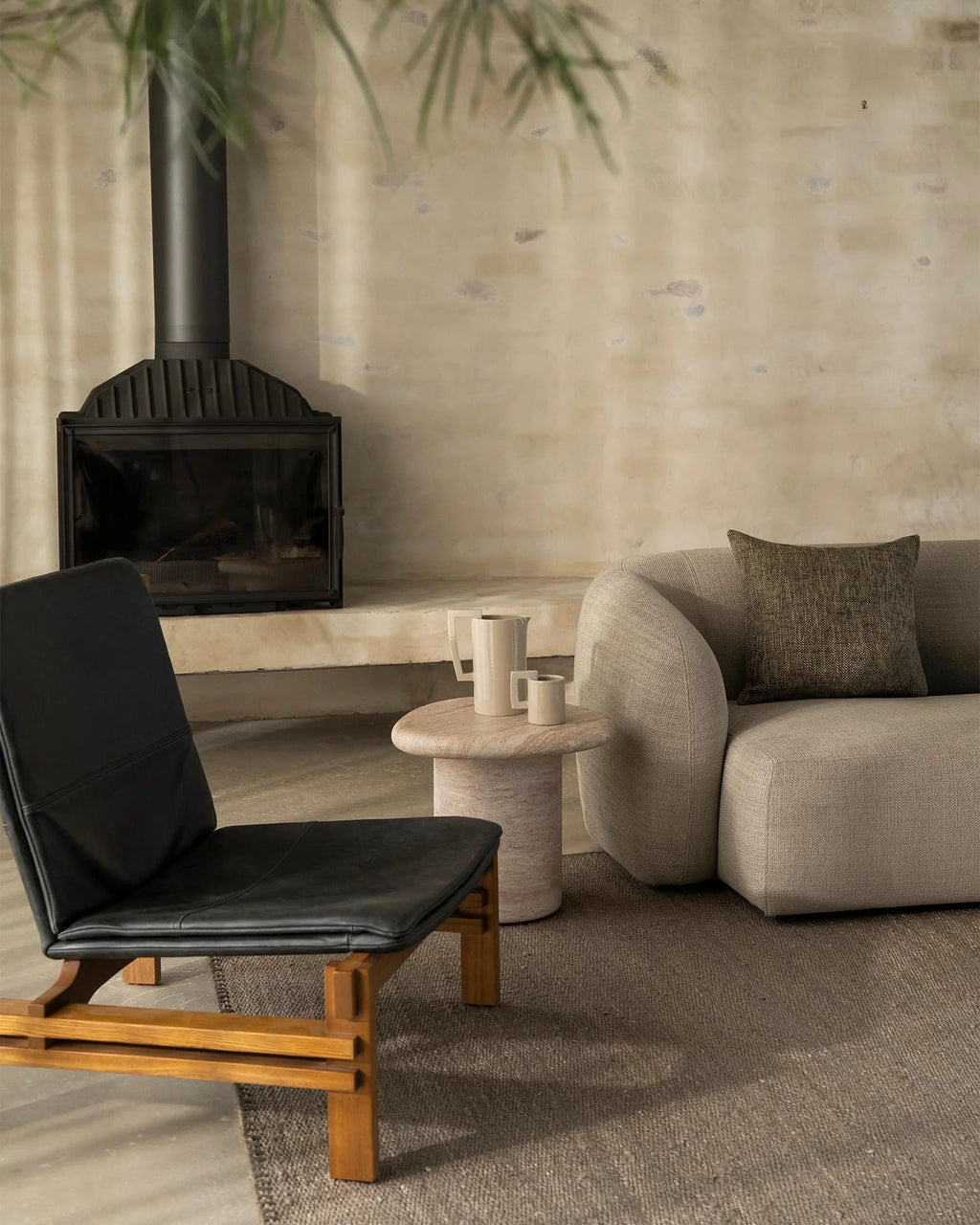 Weave Home Monroe jute rug in Flint with a black leather chair and a linen sofa