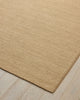 Weave Home Monroe jute rug in Oat on a pale timber floor, showing the stitched border and corner