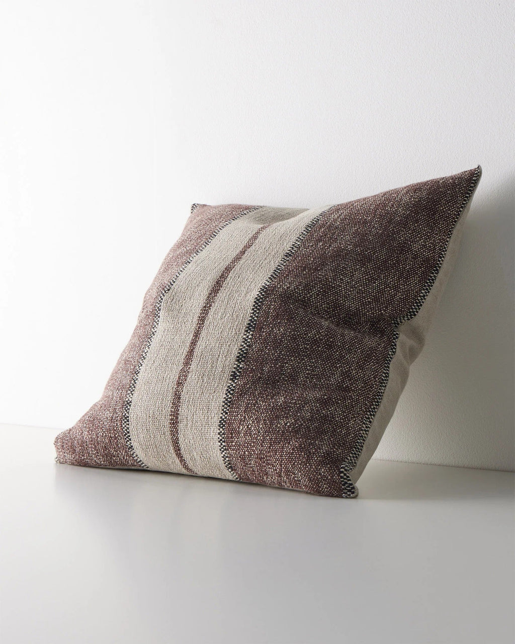 Weave Home Ottavio cushion in Mulberry, shown from an angle on a plain background.
