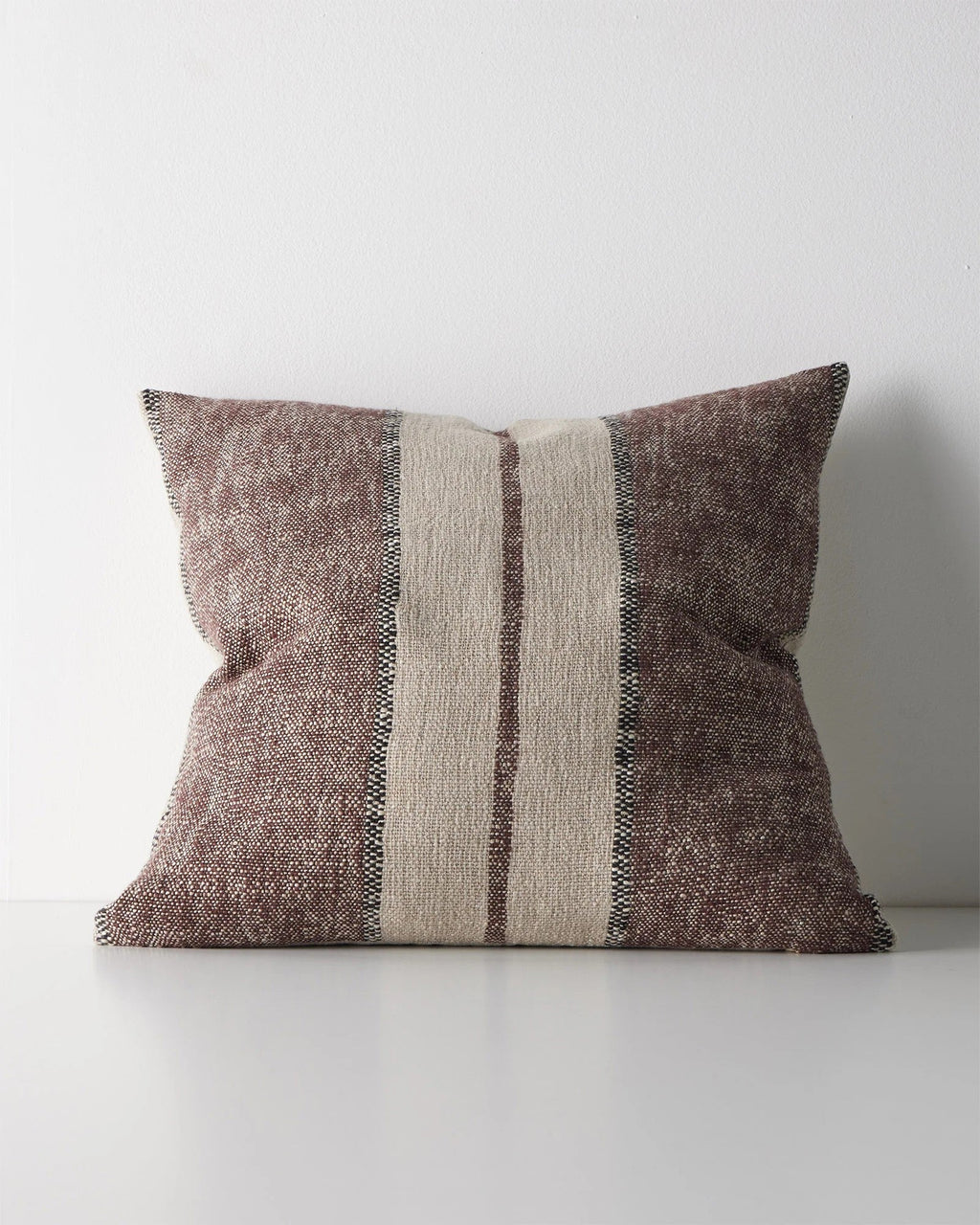 Weave Home Ottavio cushion in Mulberry on a plain background.