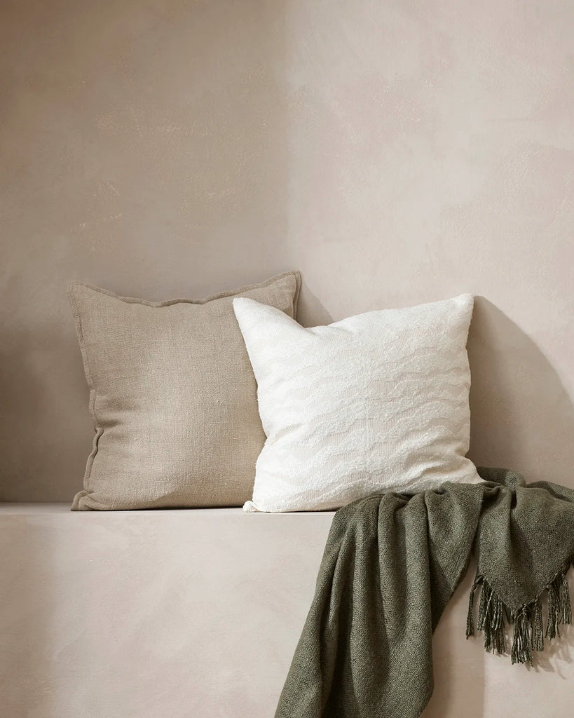 Baya cushions, including the white Aspen Snow, displayed in a contemporary home setting